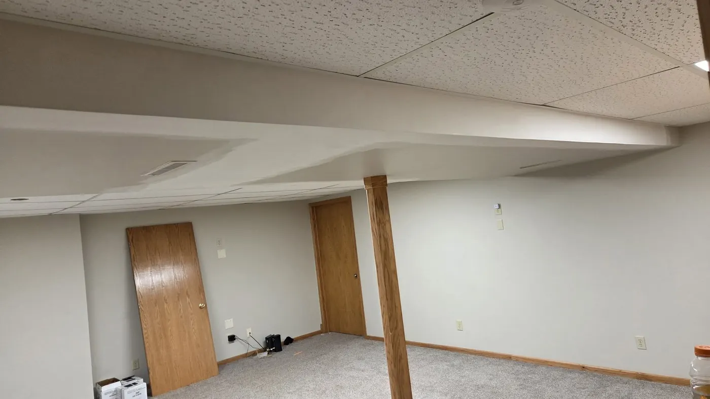 Basement ceiling and support beam repaired and painted