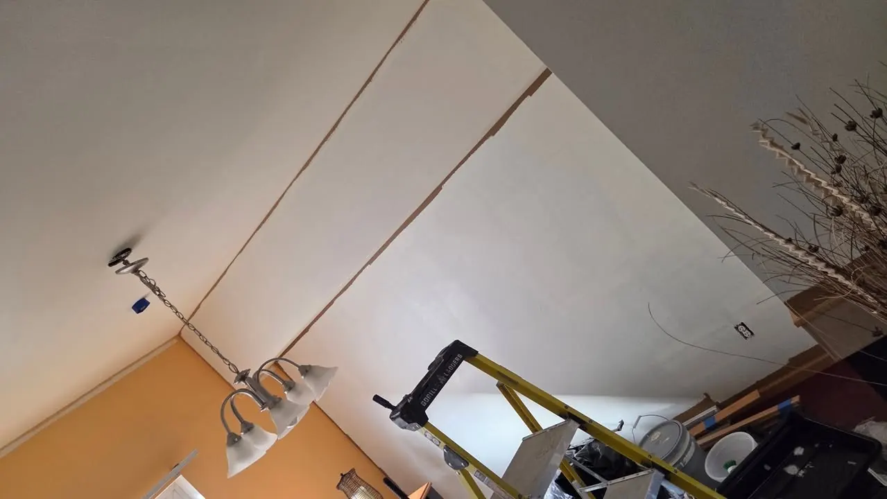 Ceiling drywall being taped and finished during a repair