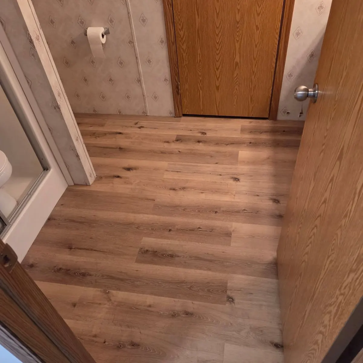 Hallway with new wood look flooring installed